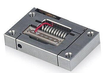 Figure 10. Low-cost piezo flexure amplified actuators for OEM application. The image shows the integrated piezo stack actuator and the preload. A position feedback sensor is optional (Image: PI)